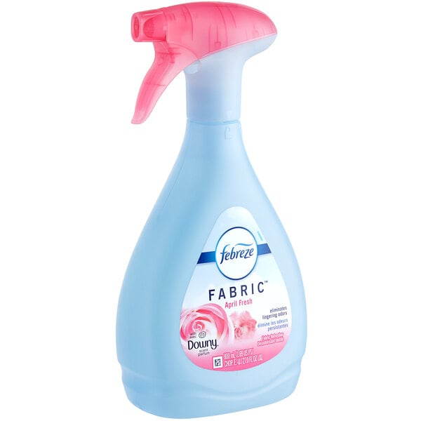 A Febreze bottle of Downy April Fresh fabric spray with a pink sprayer.