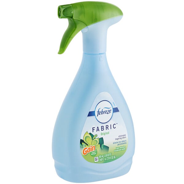 A blue and green Febreze Fabric Refresher spray bottle.