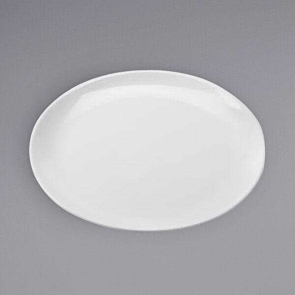 An American Metalcraft white melamine pizza plate with a small rim on a white surface.