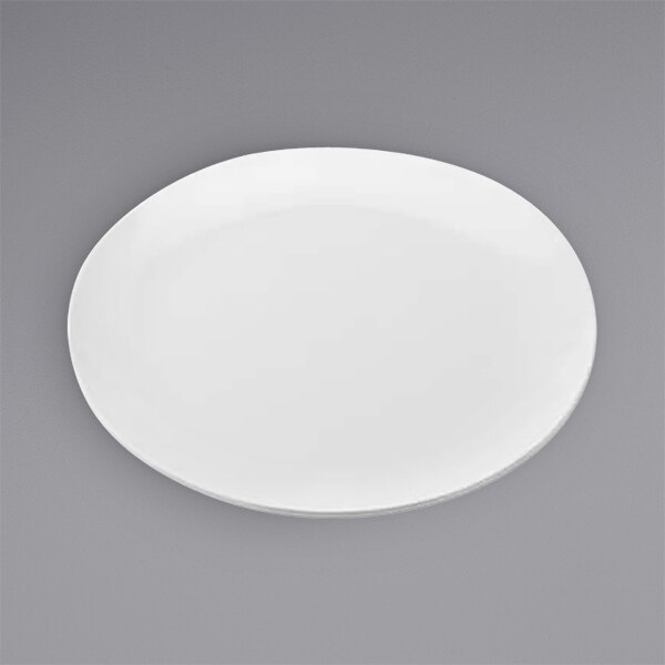 An American Metalcraft white melamine pizza plate with a small rim on a gray surface.