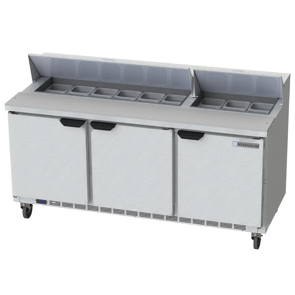 A Beverage-Air refrigerated sandwich prep table with three doors and drawers on a counter.