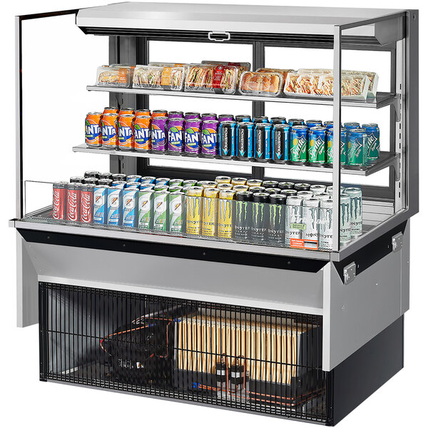 A Turbo Air drop-in refrigerated display case with drinks and snacks including soda cans.