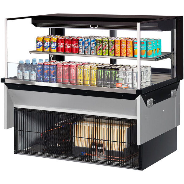 A Turbo Air drop-in refrigerated display case with drinks and cans on a shelf.
