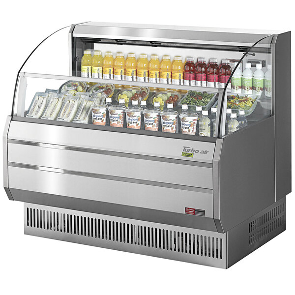 A Turbo Air stainless steel horizontal refrigerated curtain merchandiser on a counter with different drinks and beverages.