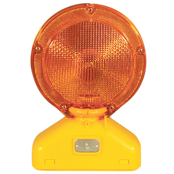 A close-up of a yellow and orange Cortina LED barricade light with a round light.