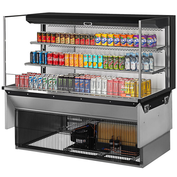 A Turbo Air drop-in refrigerated display case with a variety of cans of soda.