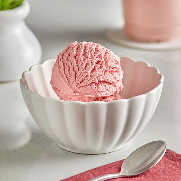 A bowl of ice cream with a scoop of Oringer Red Raspberry Puree Hard Serve Ice Cream.