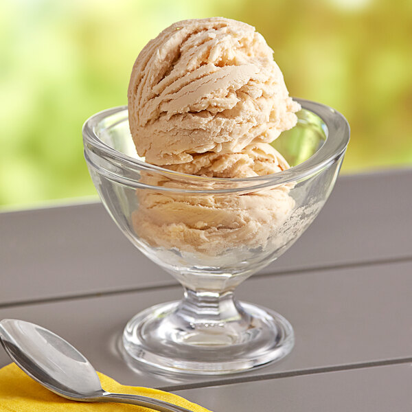 A bowl of Oringer caramel hard serve ice cream with a spoon in it.
