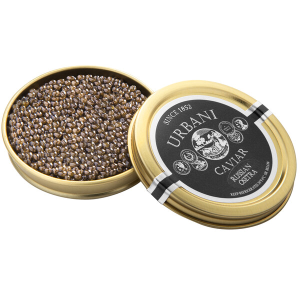 A round tin of Urbani Russian Osetra Royal Caviar with a gold lid full of black caviar.