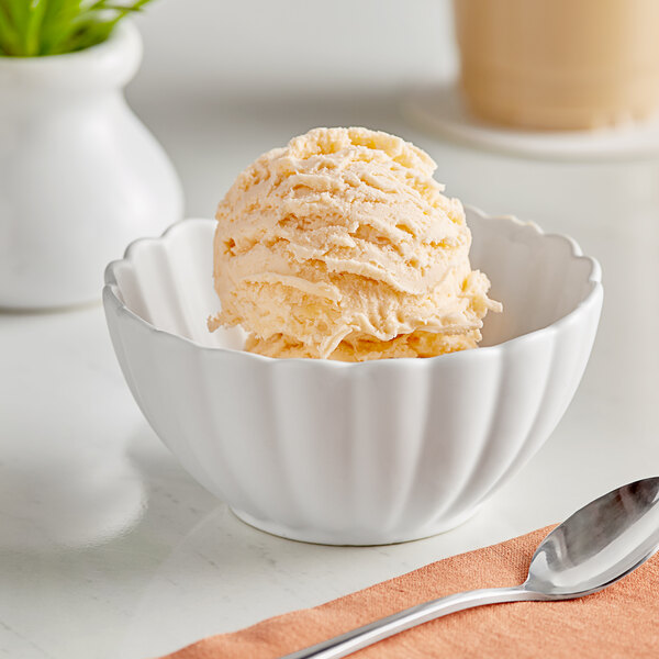 A bowl of Oringer mango ice cream with a spoon.