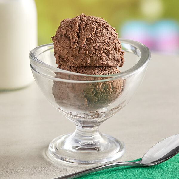 A glass bowl with a scoop of Oringer Van Daak chocolate ice cream.