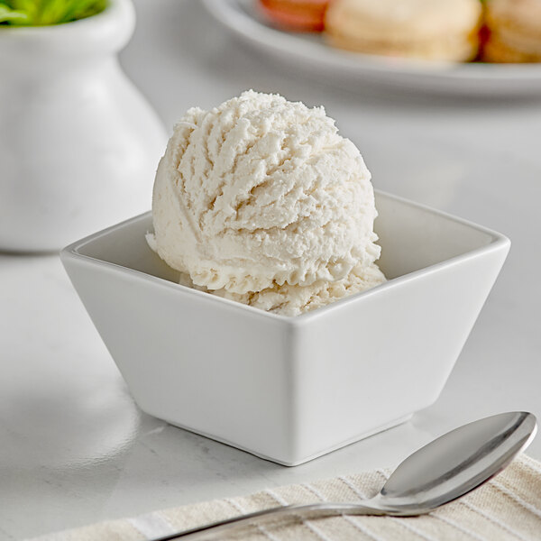 A white bowl with a scoop of Oringer coconut hard serve ice cream.