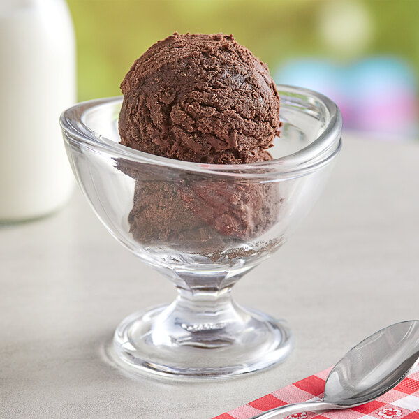 A bowl of Oringer double rich chocolate ice cream with a spoon on a red and white checkered cloth.