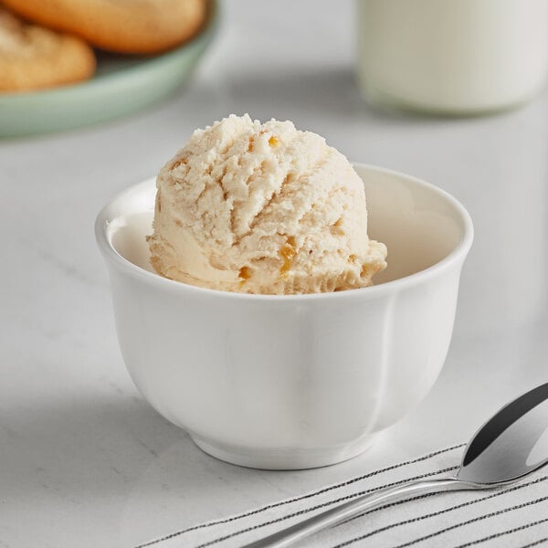 A white cup with a scoop of Oringer apple hard serve ice cream in it.