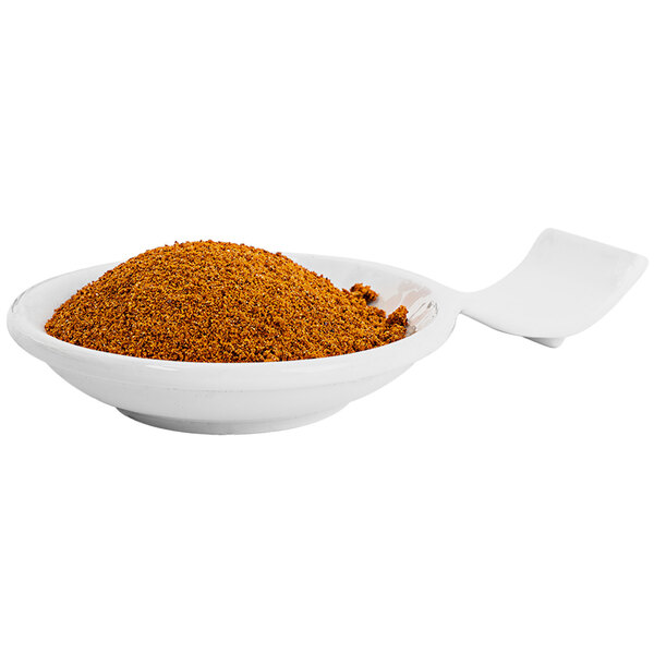 A bowl of brown Fiery Farms Red Harissa pepper powder on a white background.