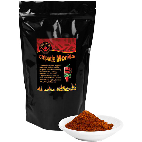 A black bag of Fiery Farms Smoked Chipotle Morita Pepper Powder next to a white bowl of red powder.
