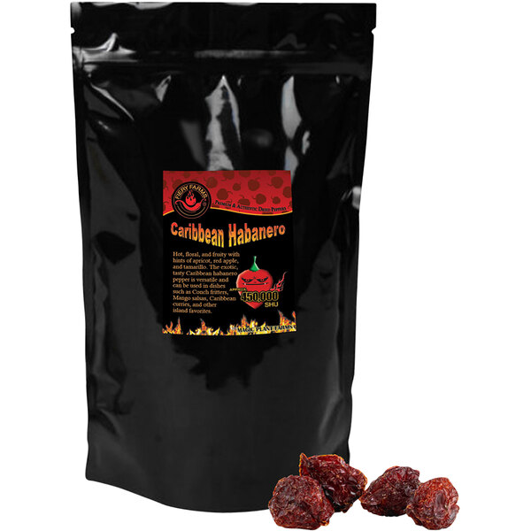 A black bag of Fiery Farms dried whole red Caribbean habanero pepper pods with a red label.