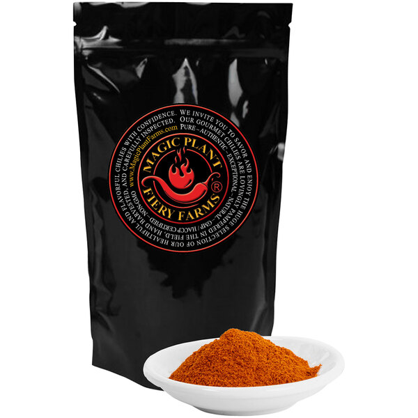 A black bag of Fiery Farms Red Dragon's Breath Pepper Powder next to a white bowl of red powder.