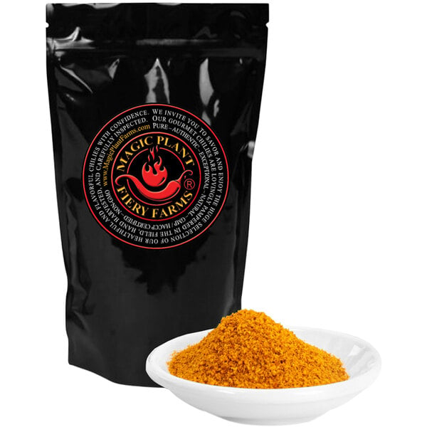 A black bag of Fiery Farms Orange Fatalii Pepper Powder next to a bowl of yellow powder.