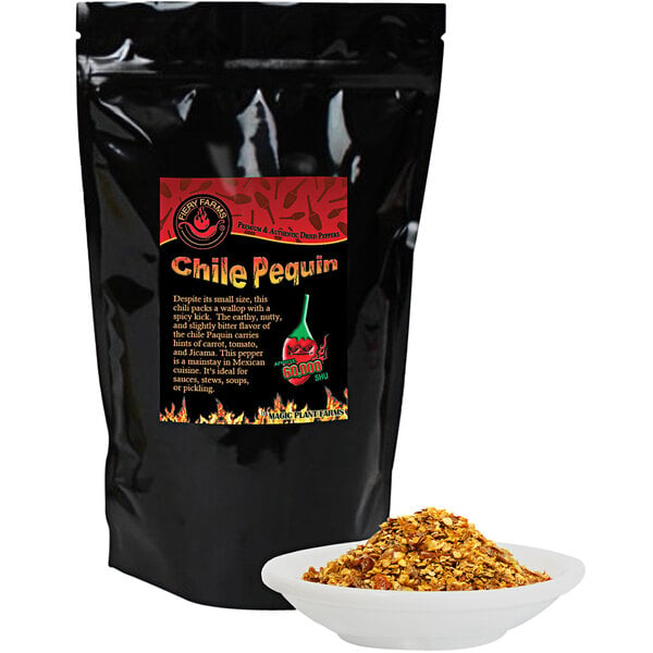A black bag of Fiery Farms Chili Pequin Pepper Flakes with a bowl of chili pepper seasoning.