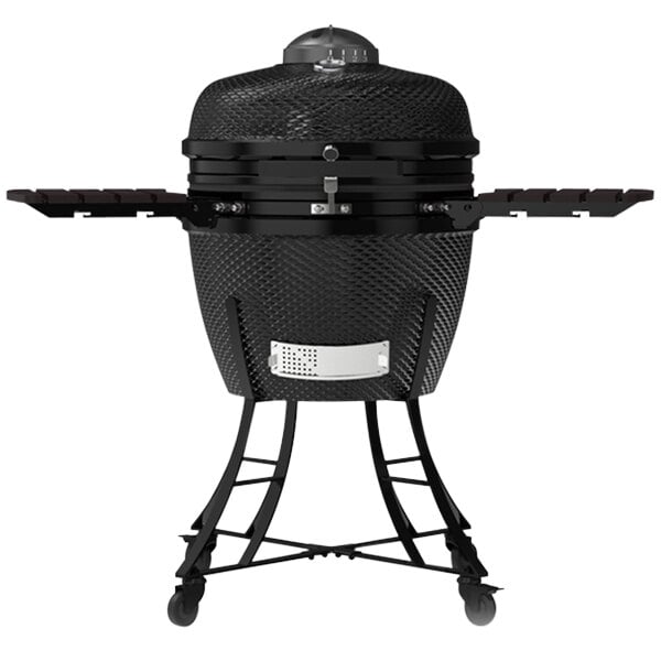 A black Louisiana Grills ceramic Kamado charcoal grill with a lid on a table outdoors.