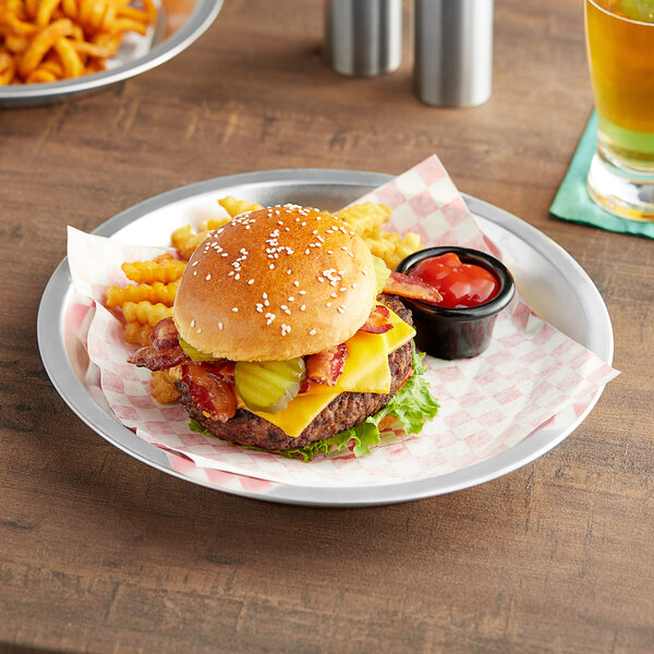 A Choice aluminum serving platter with a cheeseburger and fries on it.