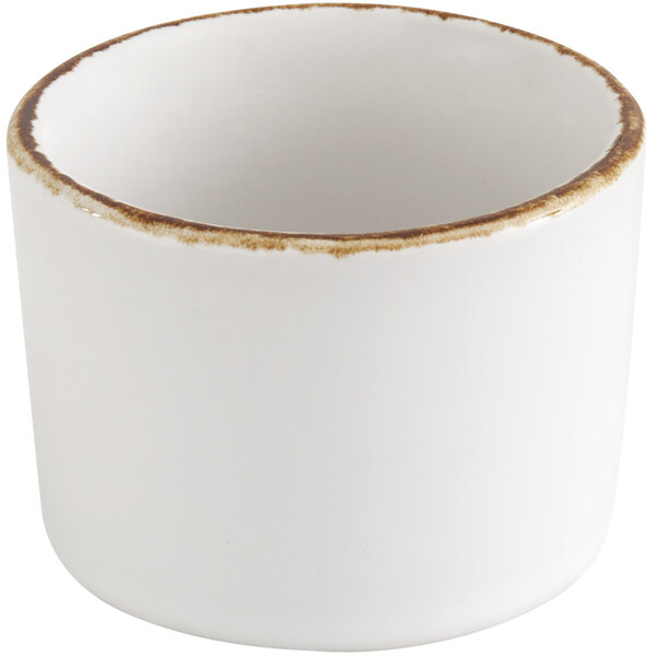 A Fortessa bright white ceramic cup with Earth hue rim.