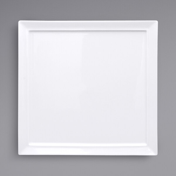A Fortessa Fortaluxe Tavola bright white square porcelain plate on a grey background.