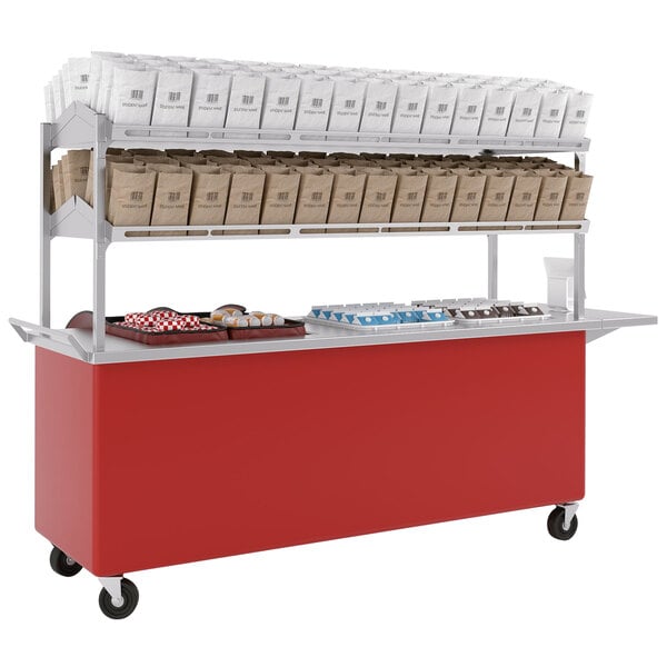 An LTI candy apple red food cart with bags on the shelf.