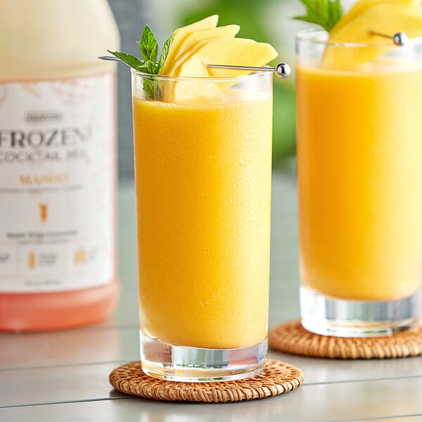 A close up of a Narvon Mango Frozen Cocktail Mix bottle with a yellow liquid inside.