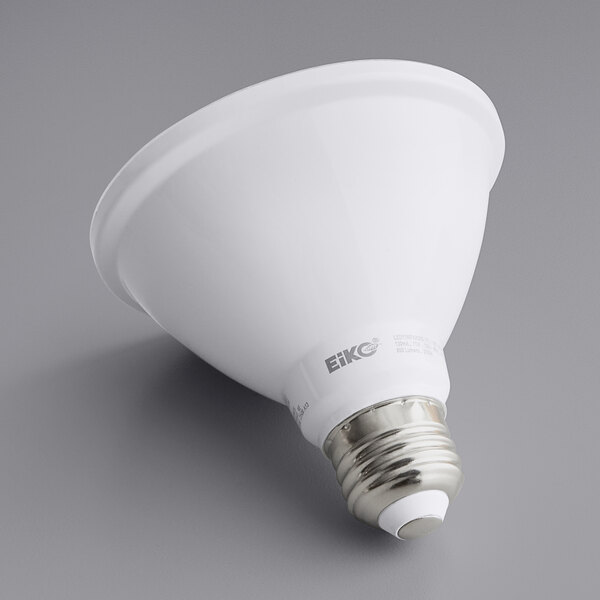 An Eiko 11 watt white LED flood light bulb with a silver base on a gray surface.
