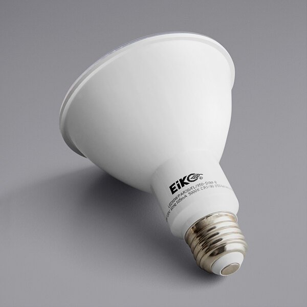A close-up of a Eiko 10 watt dimmable LED light bulb with black and white text on a label.