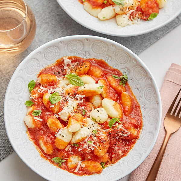 A plate of Del Destino potato gnocchi with tomato sauce and cheese.