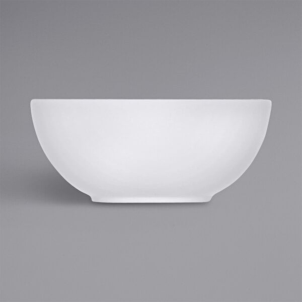 A white bowl with a white rim on a gray background.