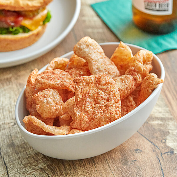 A bowl of Martin's Hot & Spicy Pork Rinds on a table.