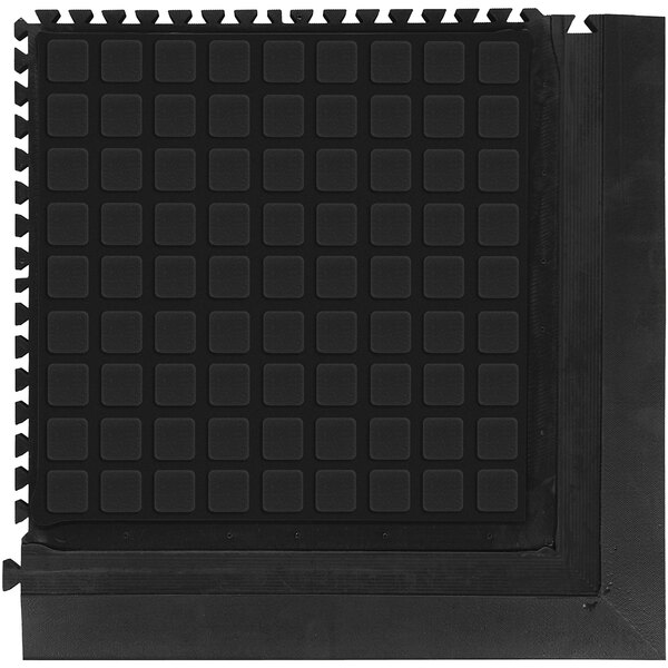 A black square M+A Matting anti-fatigue corner tile with white squares in the corners.