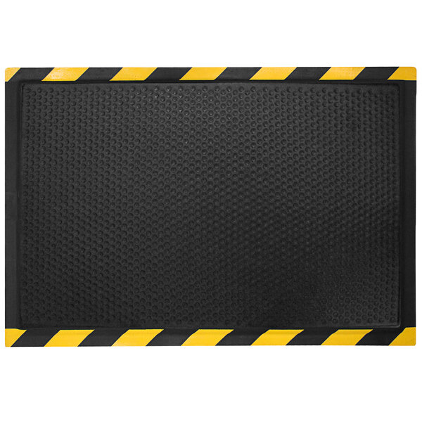 A black mat with a yellow striped border.