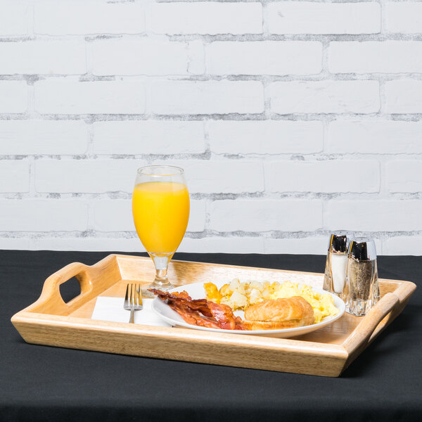 A GET hardwood room service tray with food and orange juice on it.