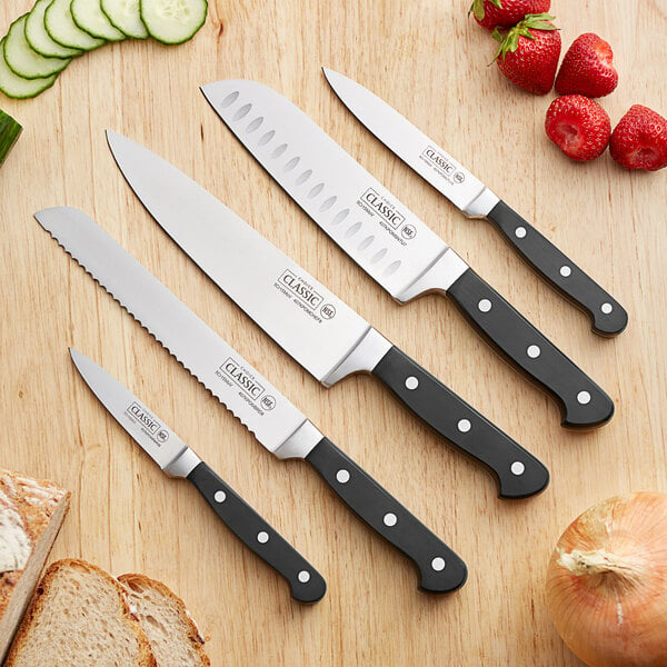 A Choice Classic knife set on a cutting board with bread and vegetables.