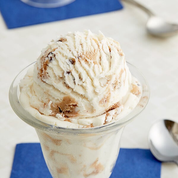 A glass cup with a scoop of Chocolate Chip Cookie Dough Ice Cream.