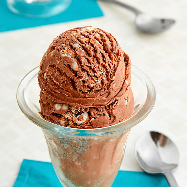 A scoop of chocolate ice cream with Cinnamon Streusel Ice Cream Topping in a glass cup.