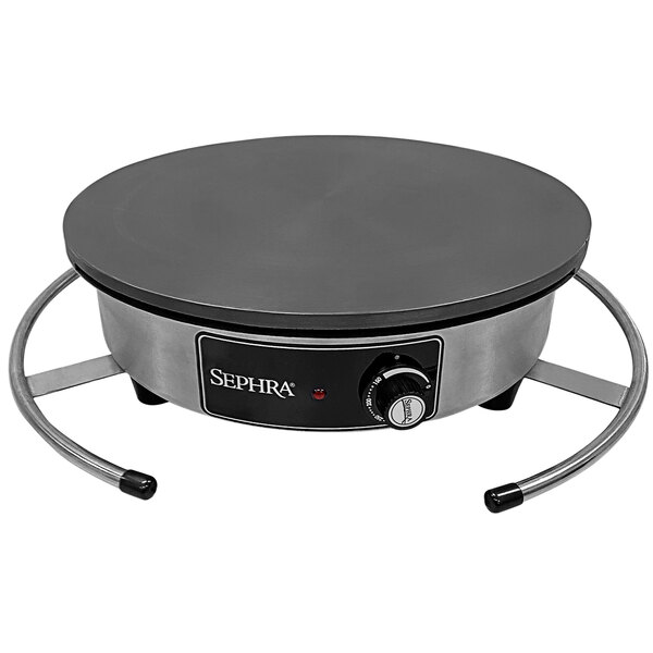 A black and silver Sephra cast iron crepe maker on a counter.