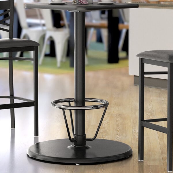 A Lancaster Table & Seating black bar height table base with a foot ring.