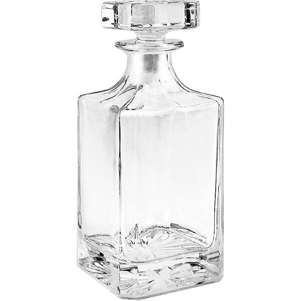 A clear glass decanter with a crystal stopper.