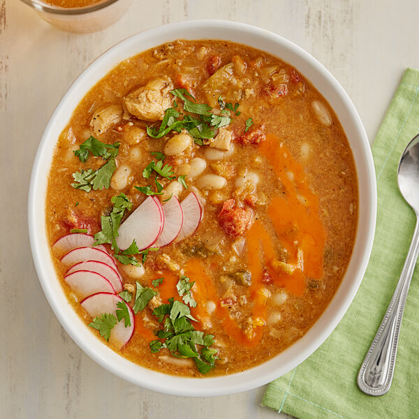 A bowl of Whitey's Chicken Chili with beans, vegetables, and meat.