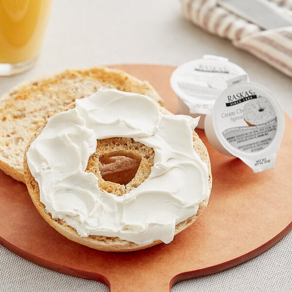 A bagel with Raskas cream cheese on it in a blurry image.