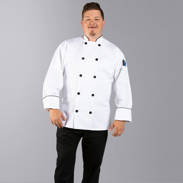 A man wearing an Uncommon Chef white long sleeve chef coat with black piping.