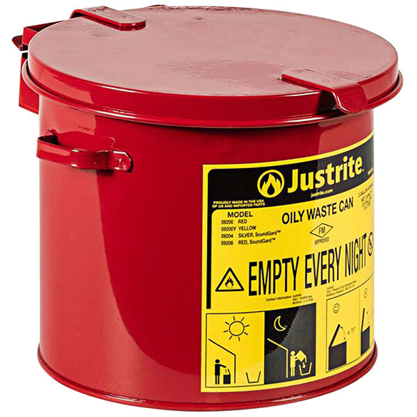 A red Justrite countertop waste can with a yellow label.