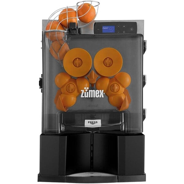 A Zumex Essential Pro juicer with oranges in it.