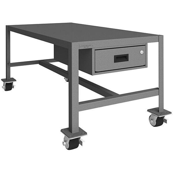 A grey metal Durham machine table with a drawer on wheels.